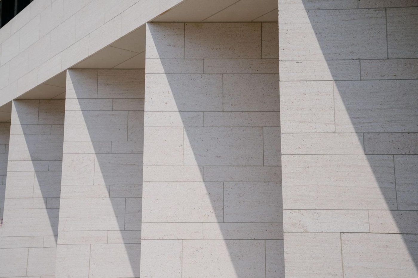 Stone colonnade casting shadows, for the corporate structuring practice