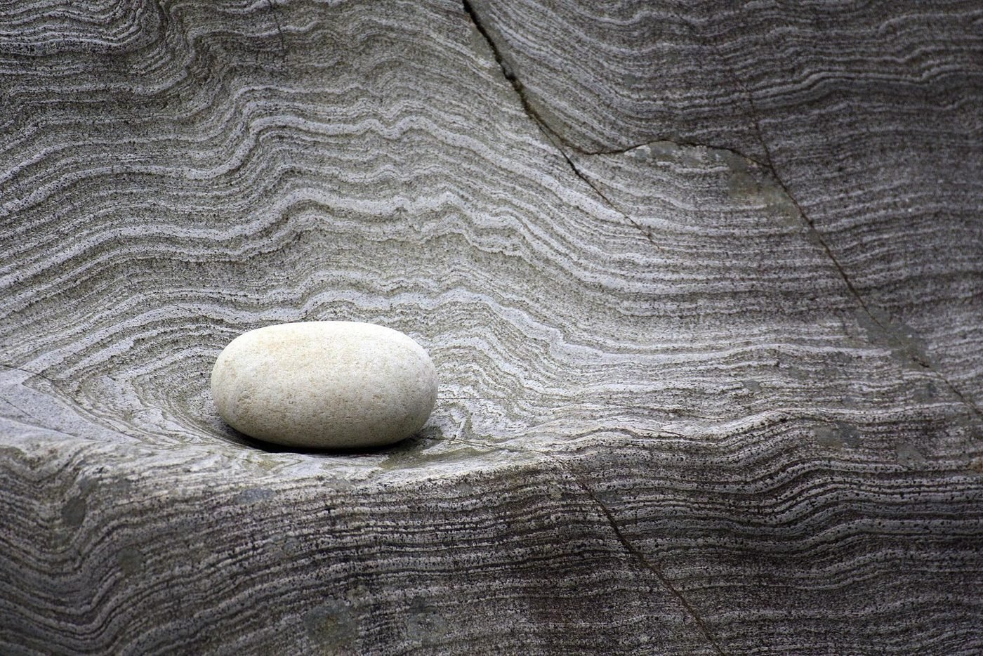 A single stone resting in layered rock, for the digital assets practice