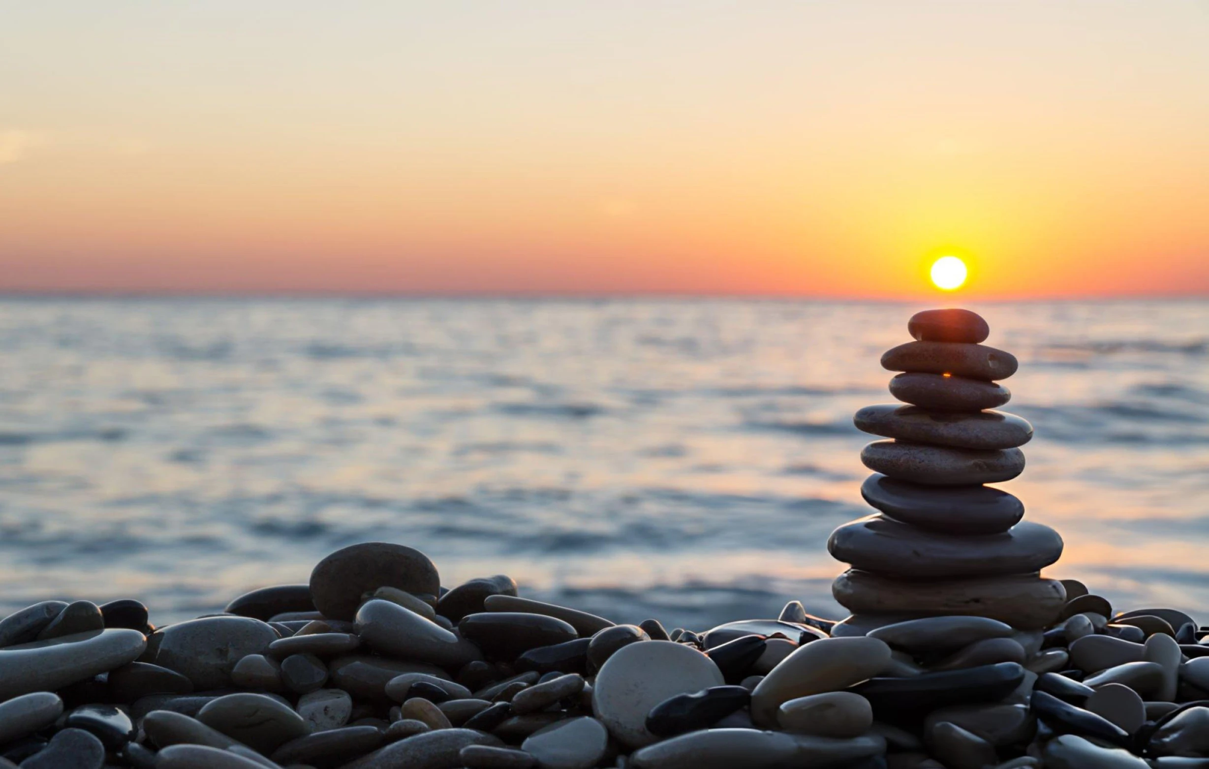 Stacked stone cairn representing the layered capital requirements of a VARA licence